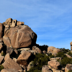 A large rock formation on top of a hill.