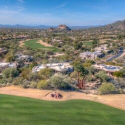A view of some houses and mountains from above.